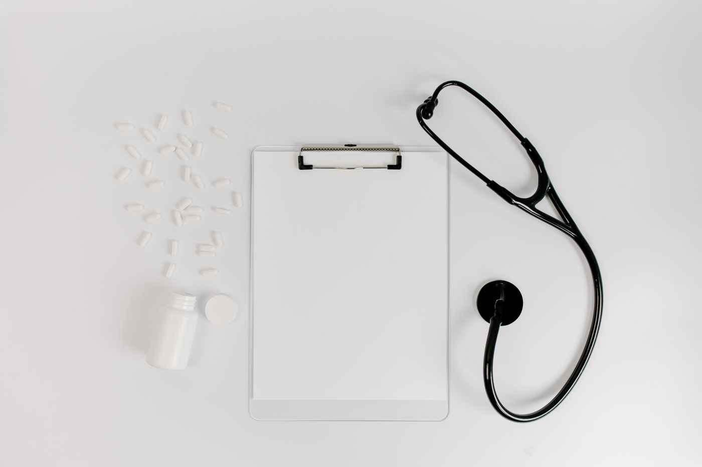 Stethoscope and blank clipboard prepared for a medical consultation